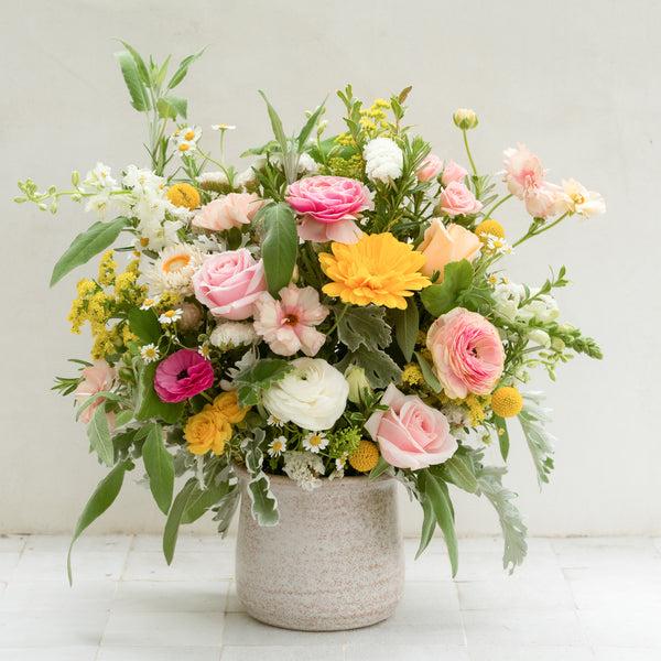 large santa barbara floral arrangement featuring white, yellow and pink flowers